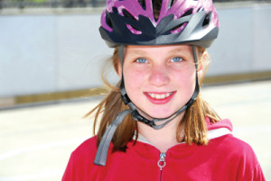 Portrait of a young girl rolleblading in a helmet