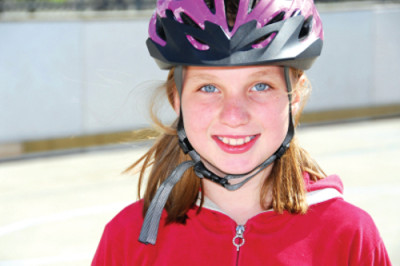 Portrait of a young girl rolleblading in a helmet