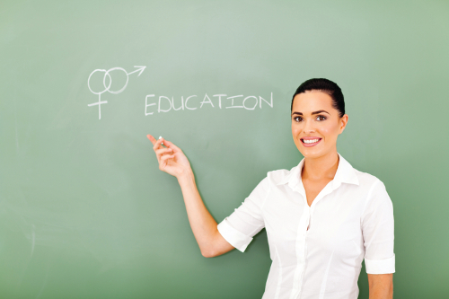female teacher pointing at sex education written on the chalkboard
